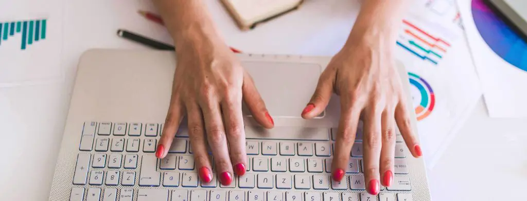 Close up of busy female hand typing on keyboard (copy-paste-emails)